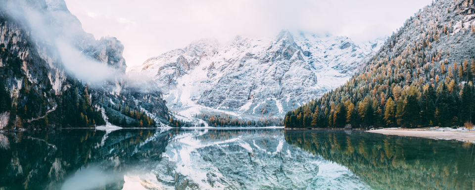 A lake surrounded by snowy mountains.