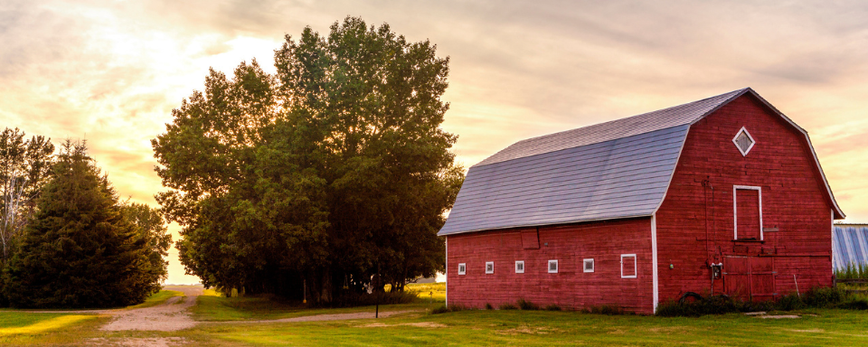 A red barn at sunset.