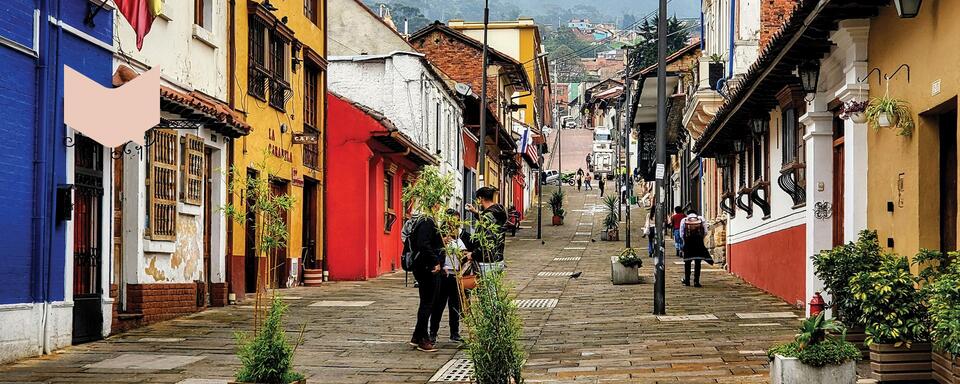 people walking on a colonial street in Bogota, Colombia